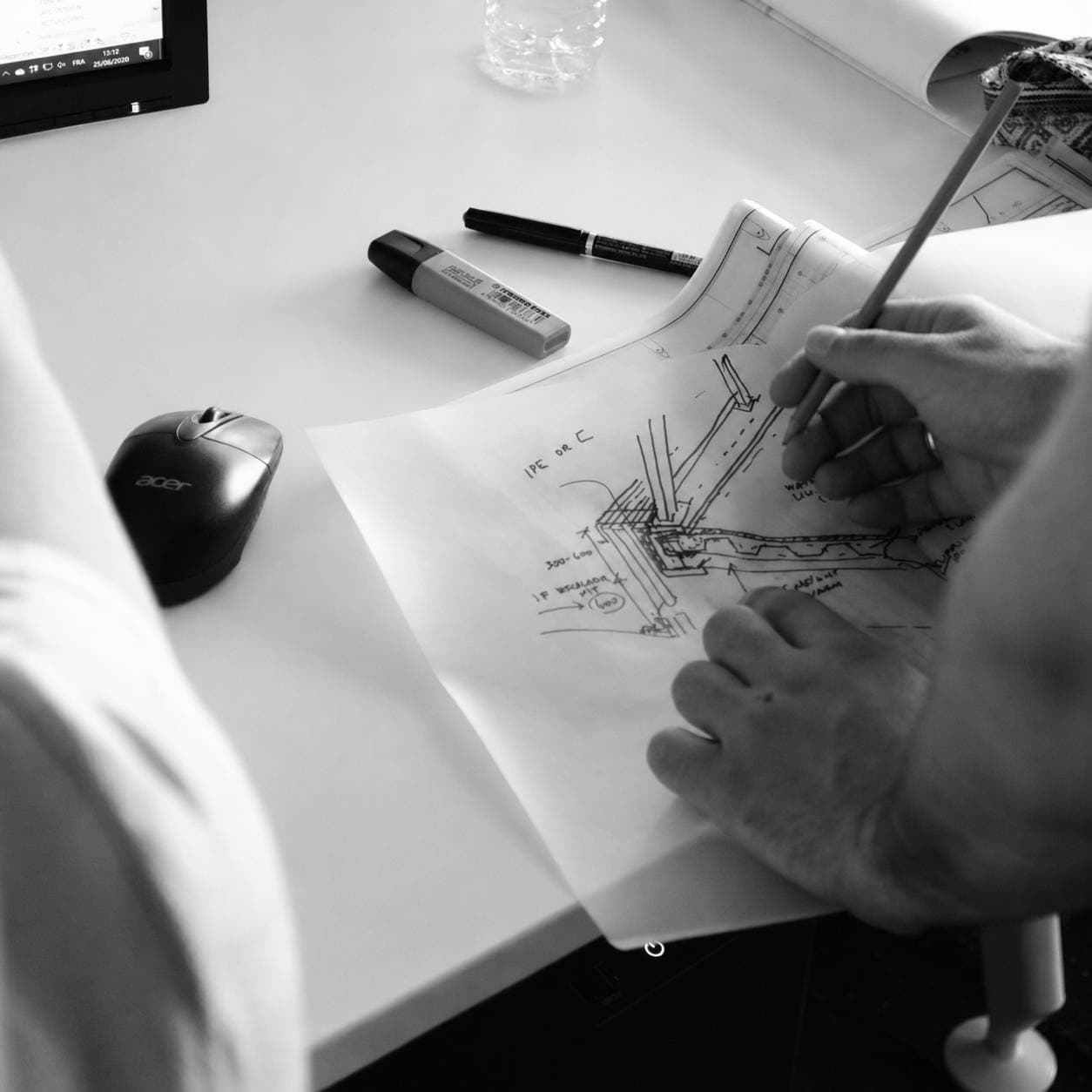 Architect sketching structural design details and plans by hand